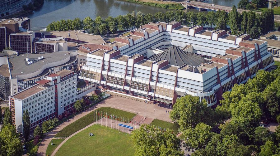 Vue aérienne du Palais de l'Europe, l'hémicycle est présent au centre de l'image, entourée par les bureaux comme si les droits étaient protégés par une forteresse.